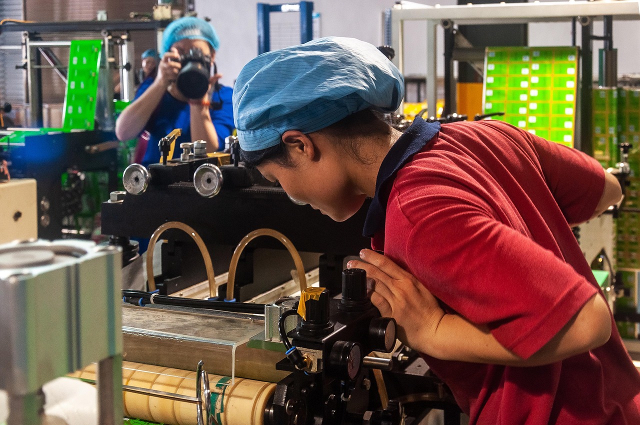 print shop worker operating machine